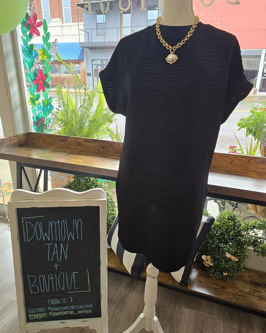 Black textured shift dress with gold chain necklace