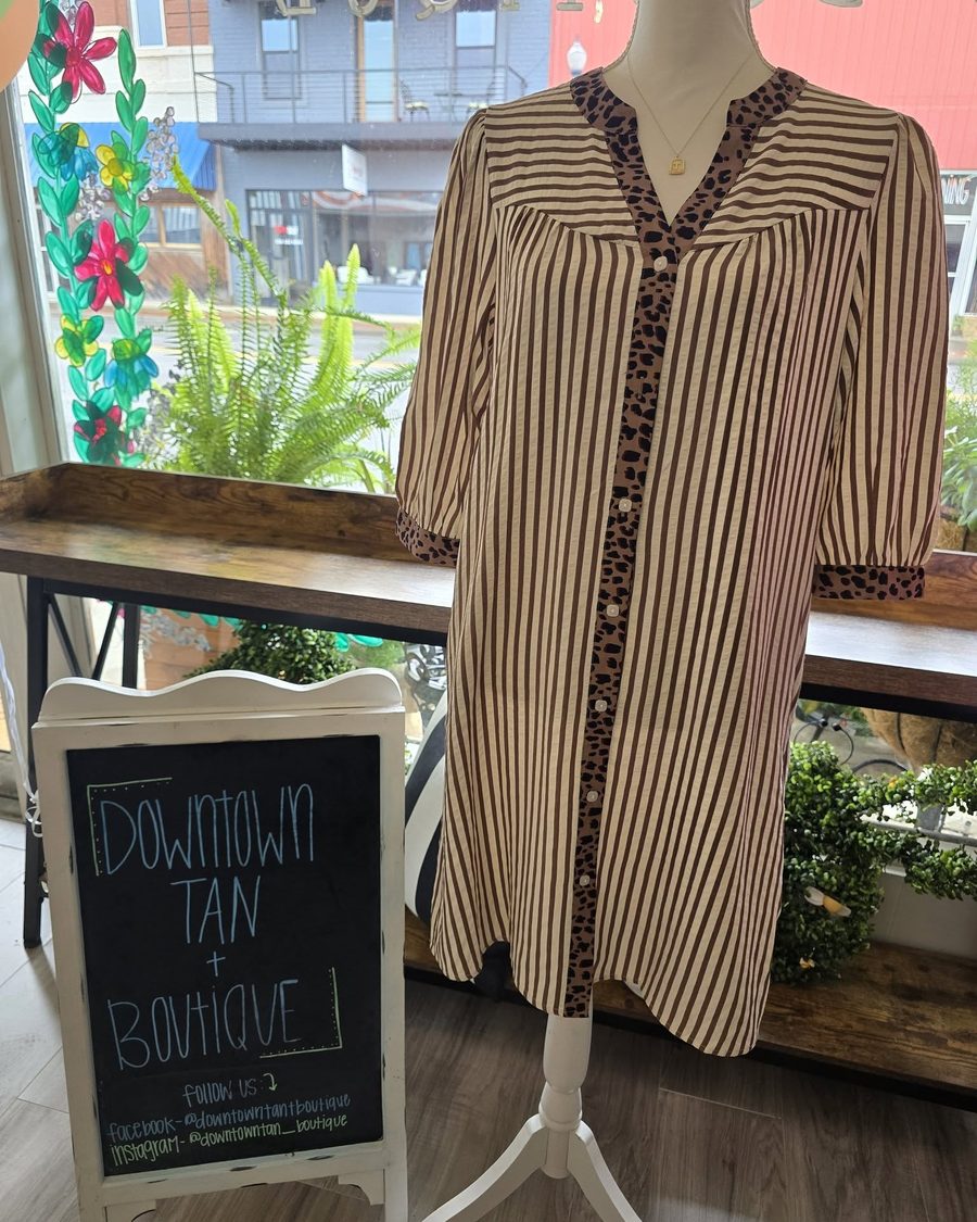 Brown striped button dress with leopard trim on a mannequin