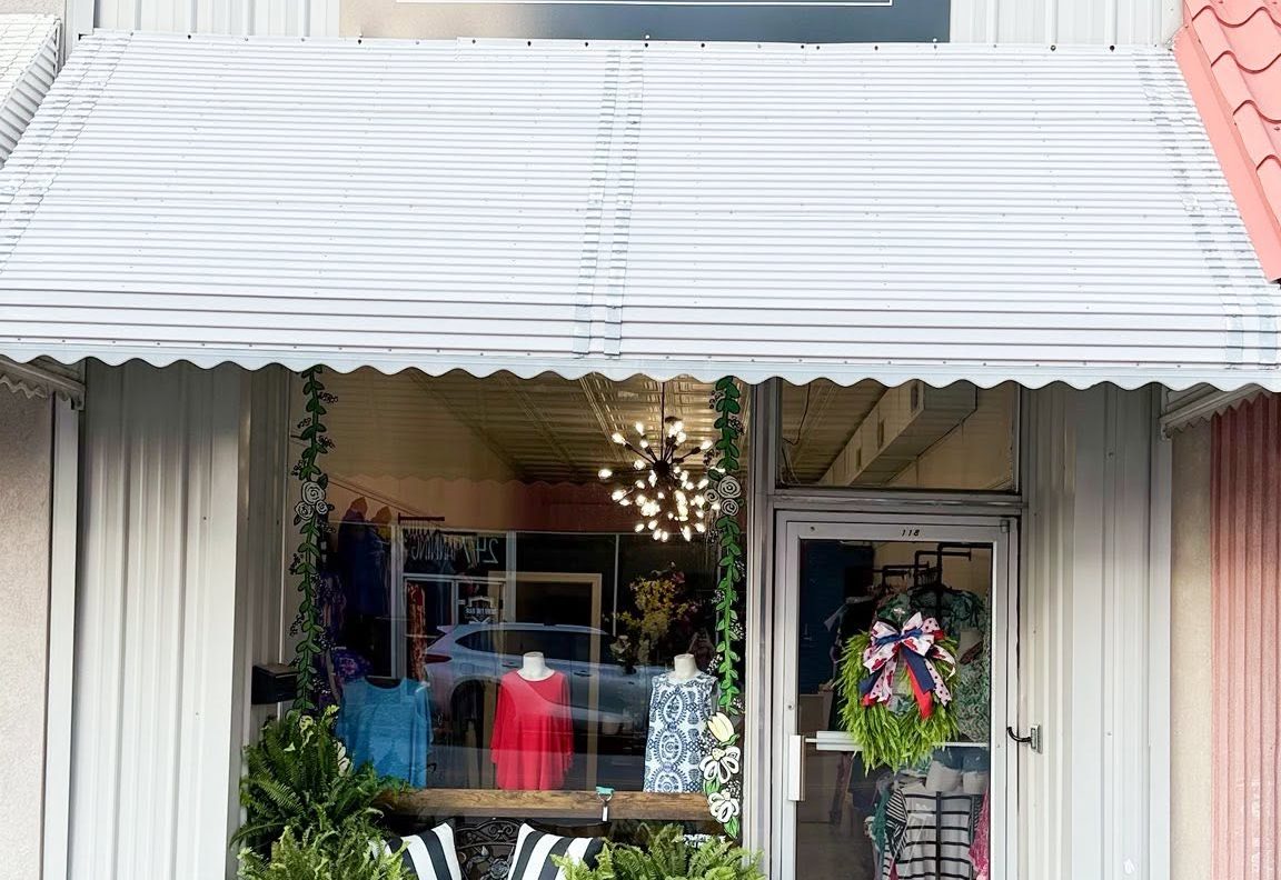 Downtown Tan + Boutique storefront on North Center Avenue with sign, awning and window display